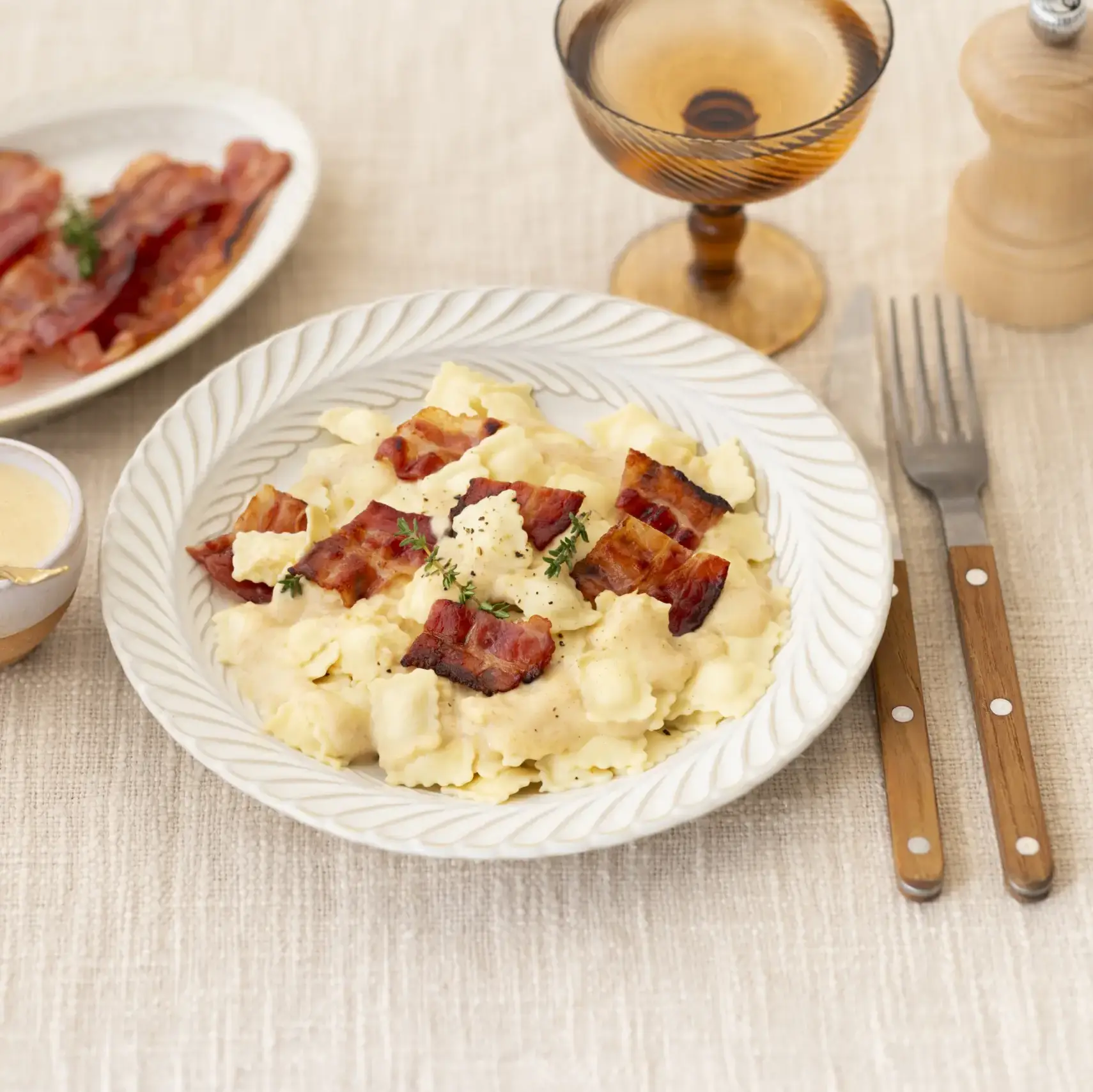 A picture of Goat Cheese Ravioles with Thyme Cream & Crispy Bacon